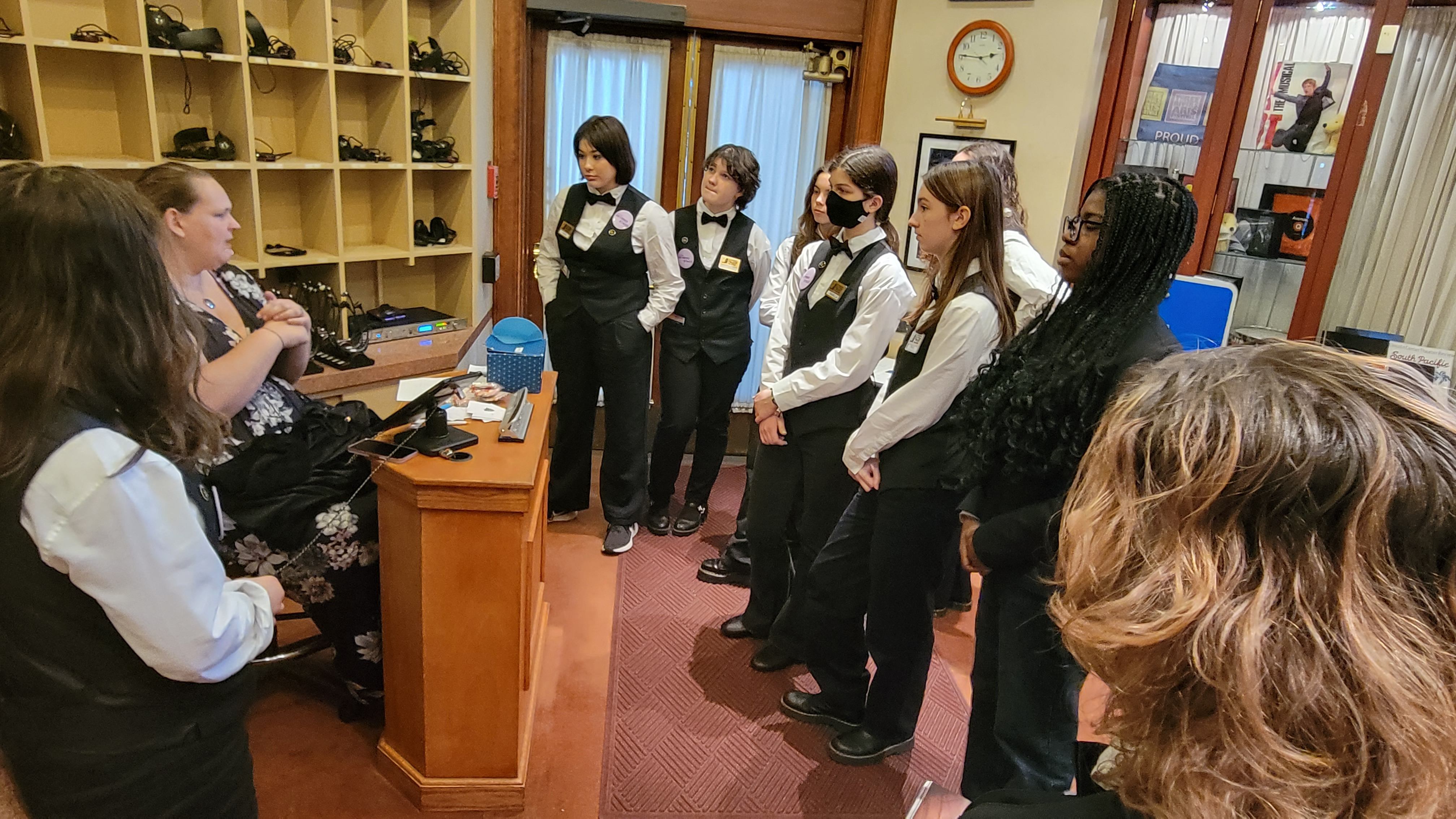 students dressd in Trust volunteer uniforms in the accessiblity area of the Benedum Center