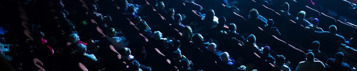A birds eye view of rows and rows of full seats during a performance