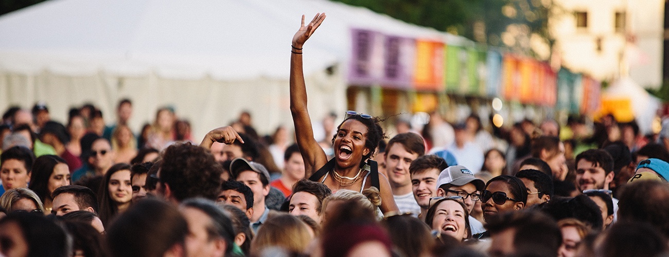 woman jumping in the air in a crowd of people