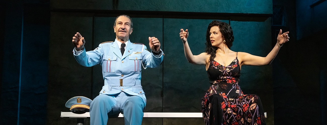 Sasson Gabbay, right, teaching conducting hand movements to Janet Dacal, right, in the national tour of the band's visit