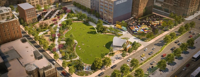 Aerial view of an urban park with a large green lawn, walking paths, scattered trees, colorful playground, and nearby buildings. People are relaxing on the grass and cars are driving on the adjacent road.