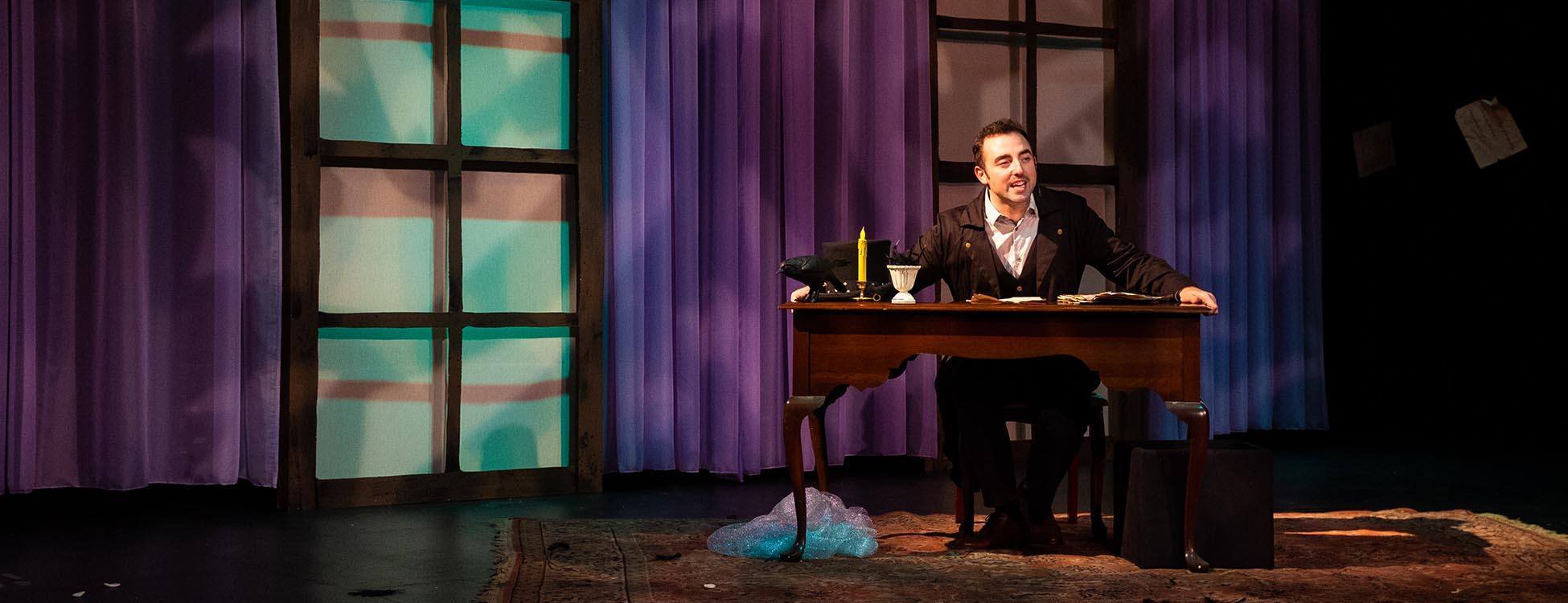 Header image of Edgar sitting alone at desk