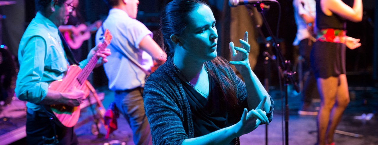 an ASL interpreter on stage during a show