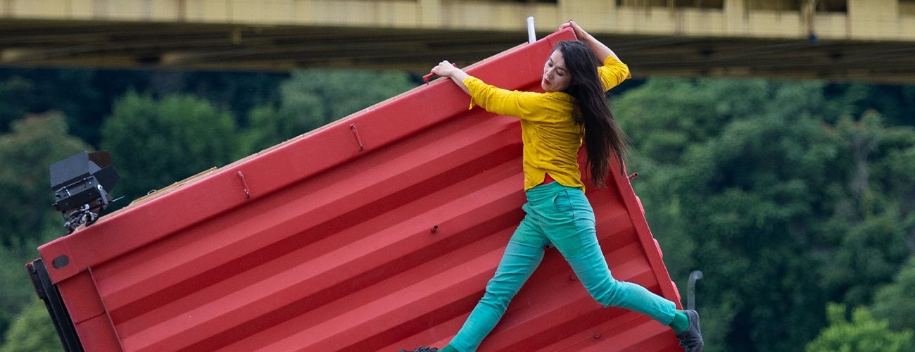 header image of Satchie Noro atop a shipping container