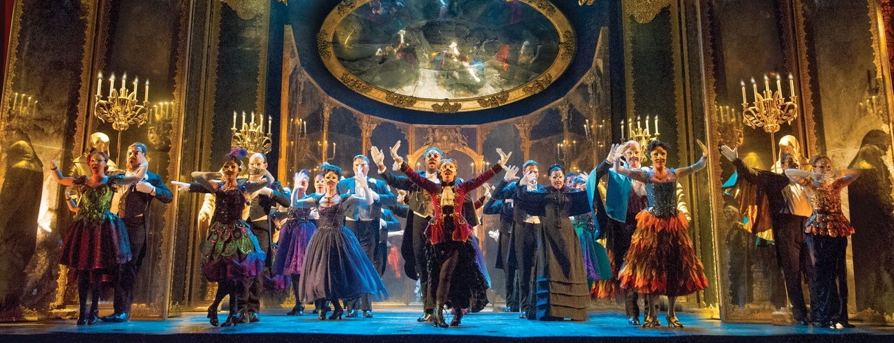dancers in masquerade on a stage
