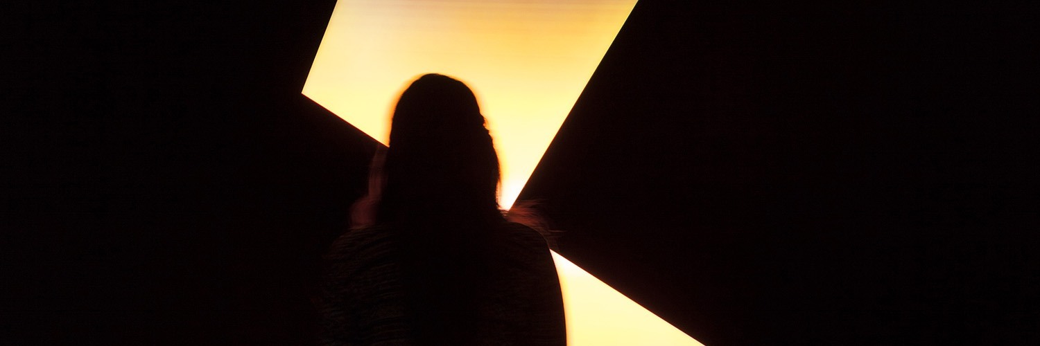 patron examining light sculpture