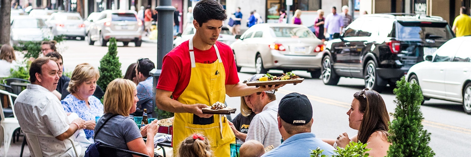 a family being served at an outdoor restaurant