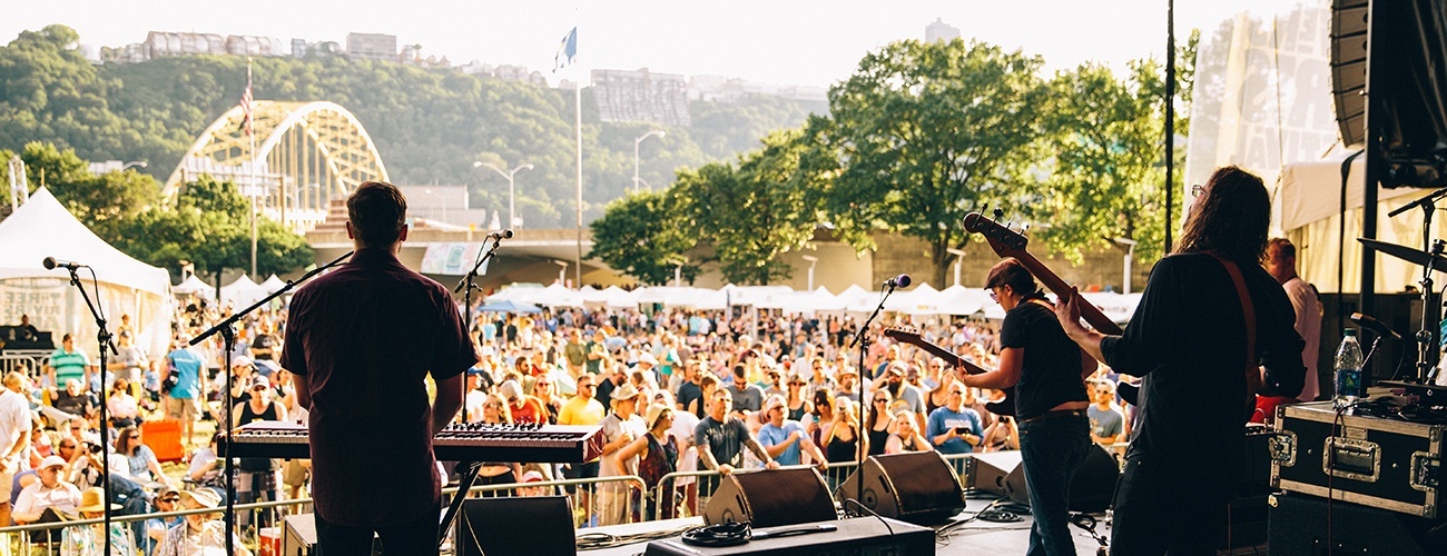 a crowd watches a concert at the Three Rivers Arts Festival in point state park