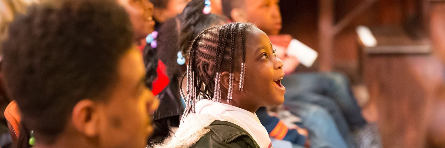 a little girl is captivated by a stage performance