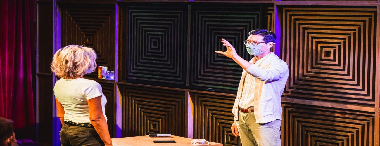 Jon Tai completing a magic trick with guest at Liberty Magic