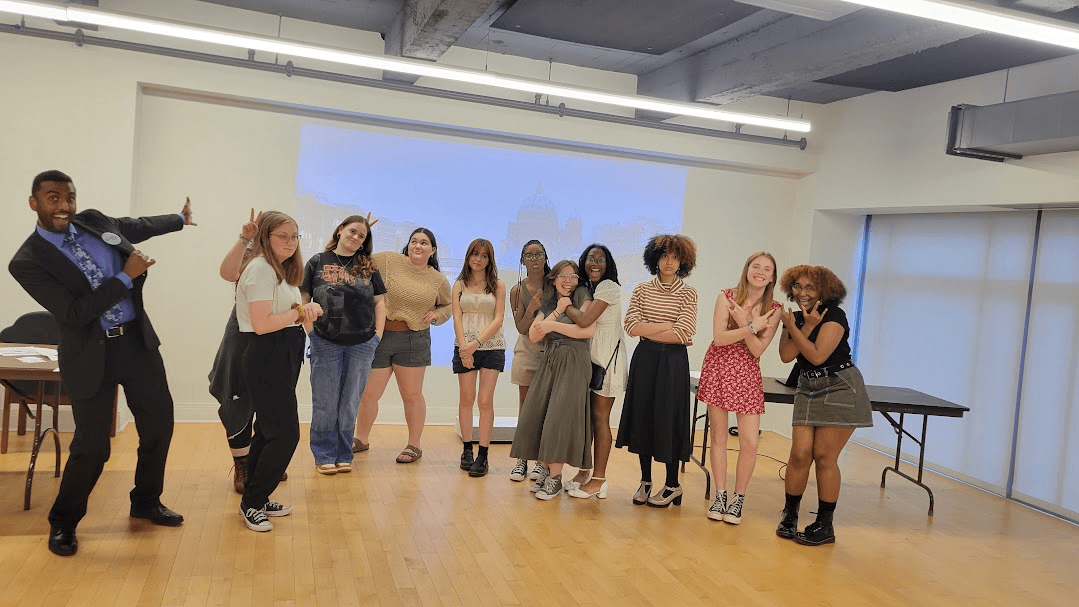 A group of young volunteers from the Beyond the Stage program pose for a picture