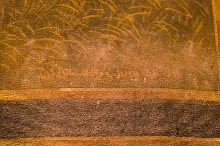 a detail shot of the dating and signature on the curtain reading 'T.J. Collins July 26 1911'