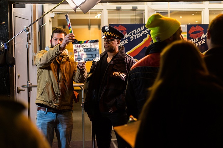 members of the cast and crew stand in front of the harris theater
