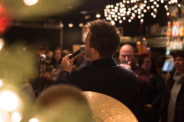 a man sings in front of a crowd