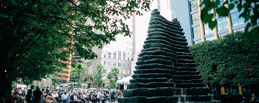 a crowd, on the left, beside the large katz plaza fountain