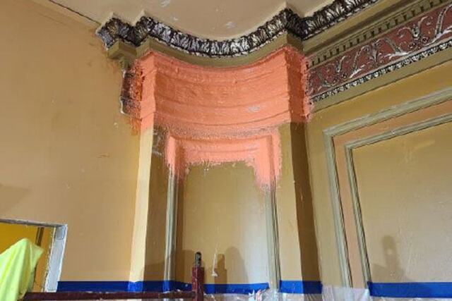 Corner of the Benedum Center with orange putty on the walls where the plasters will be applied.