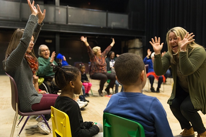 a wide shot of an intergenrational education workshop