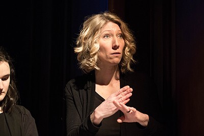 sign language interpreter signing for a performance