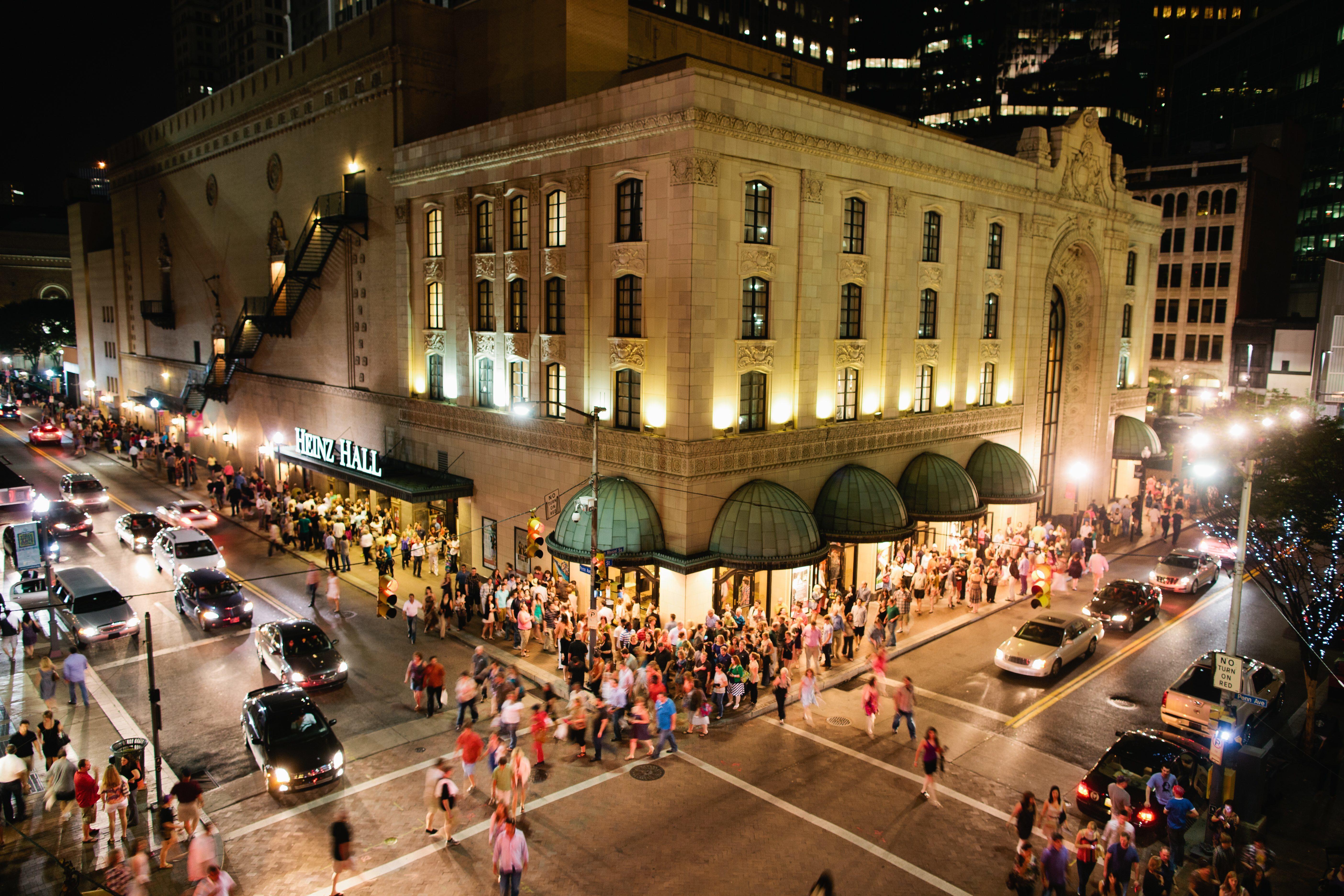 Heinz Hall exterior at night with crowds on the sidewalk. Photo: Joey Kennedy