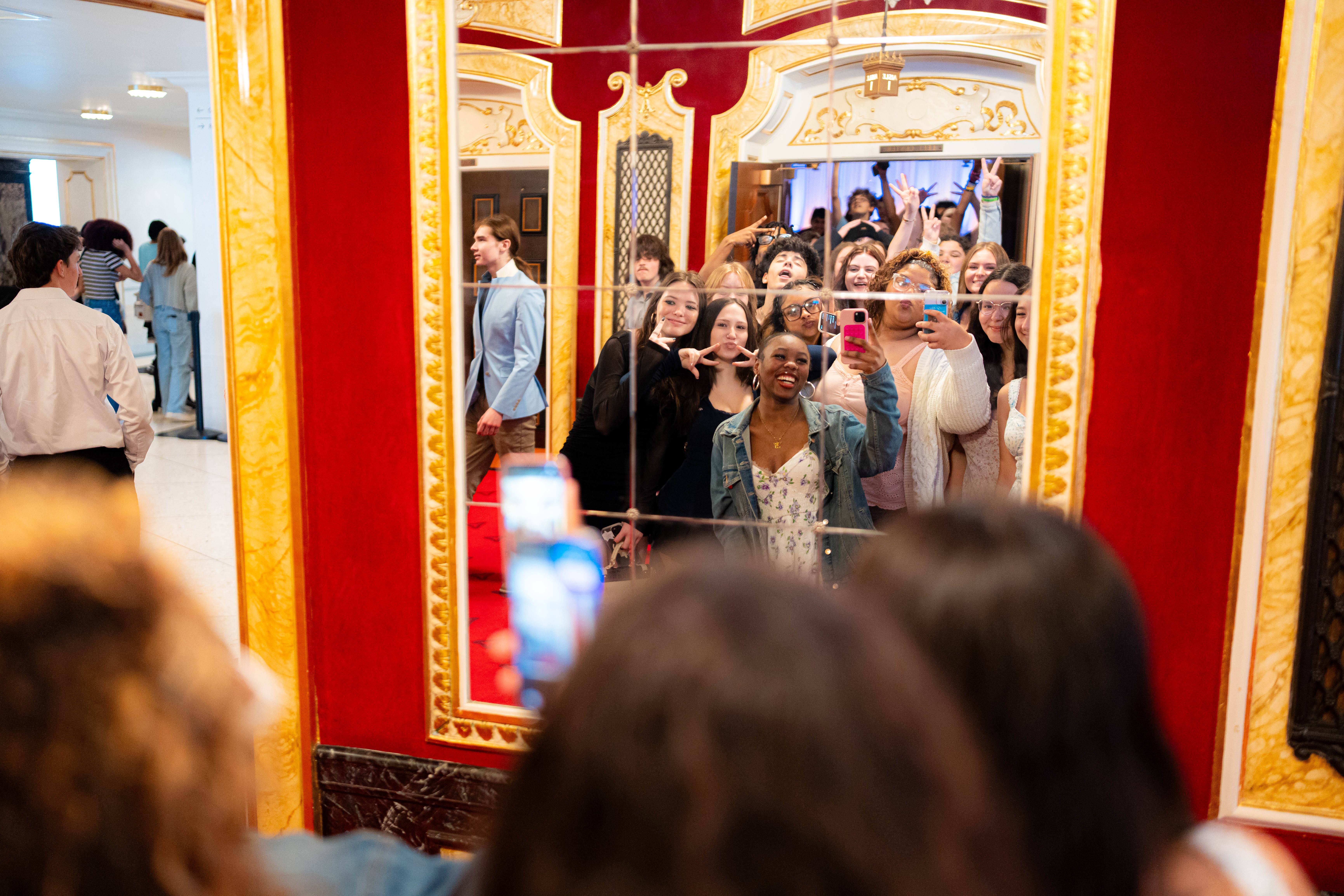 Students taking a group photo in a Heinz Hall mirror during a Schooltime visit
