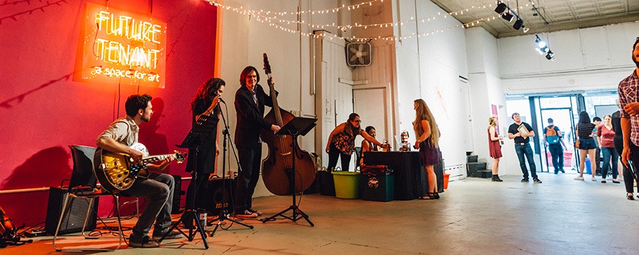 a band plays in the future tenant gallery space