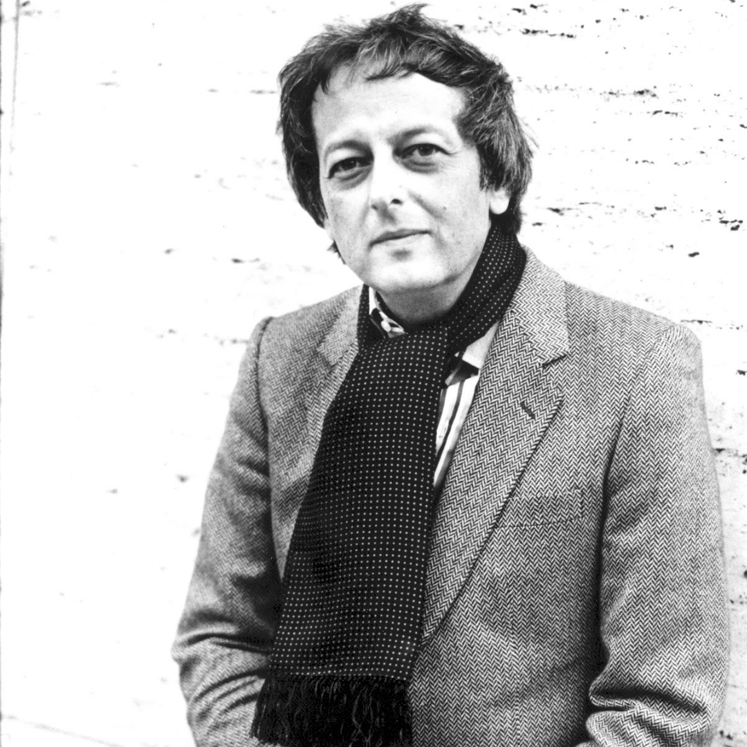 André Previn in front of brick wall