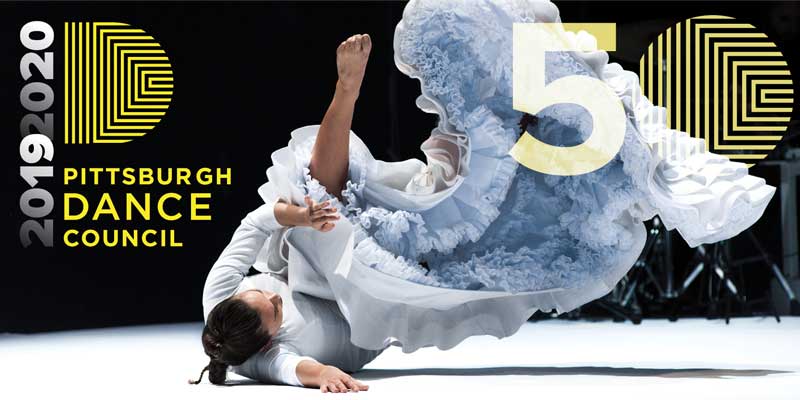 dancer rolling on the ground, foot in the air and toes pointed. Pittsburgh Dance Council 2019-2020 50th Anniversary season
